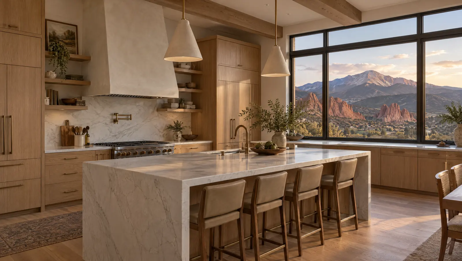 Concept kitchen in Colorado Springs with white oak cabinetry, a quartzite island and a west-facing view toward red rock and a mountain peak